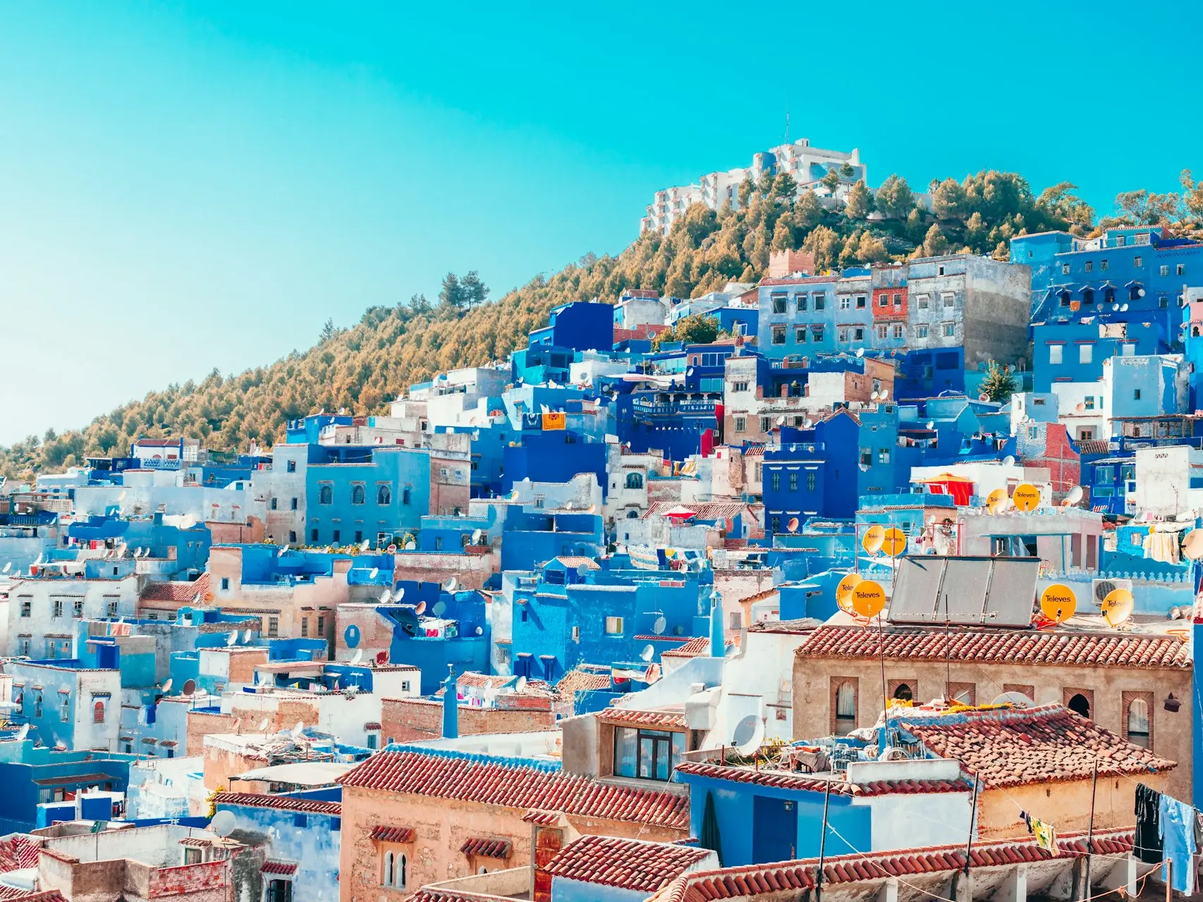 blue and white painted houses on the cliff